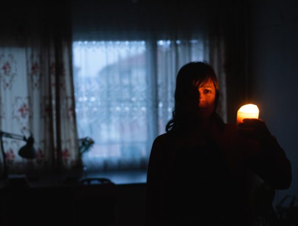 woman inside a dark house due to power outage